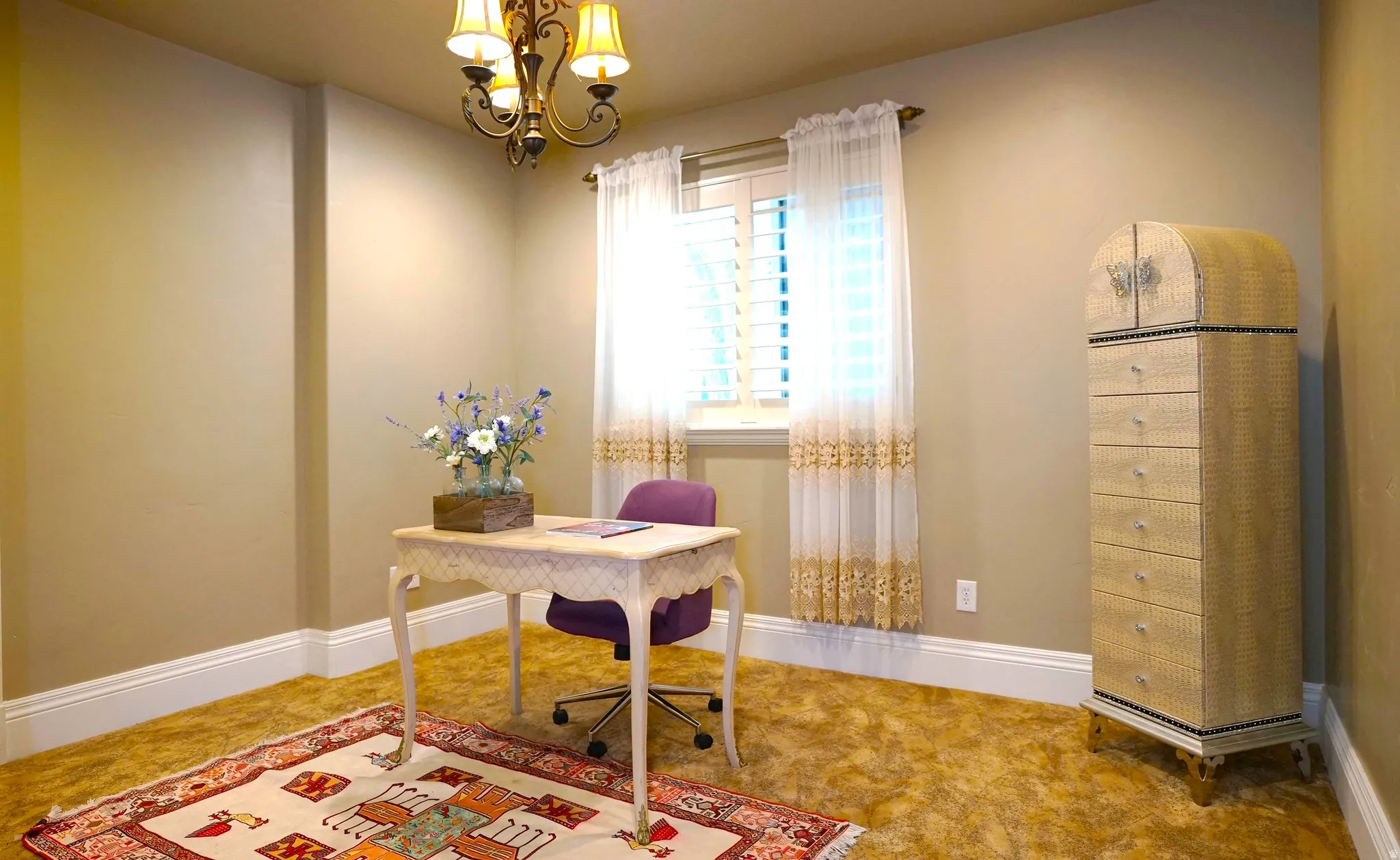 Window with plantation shutters, overhead chandelier, and extensive baseboard molding