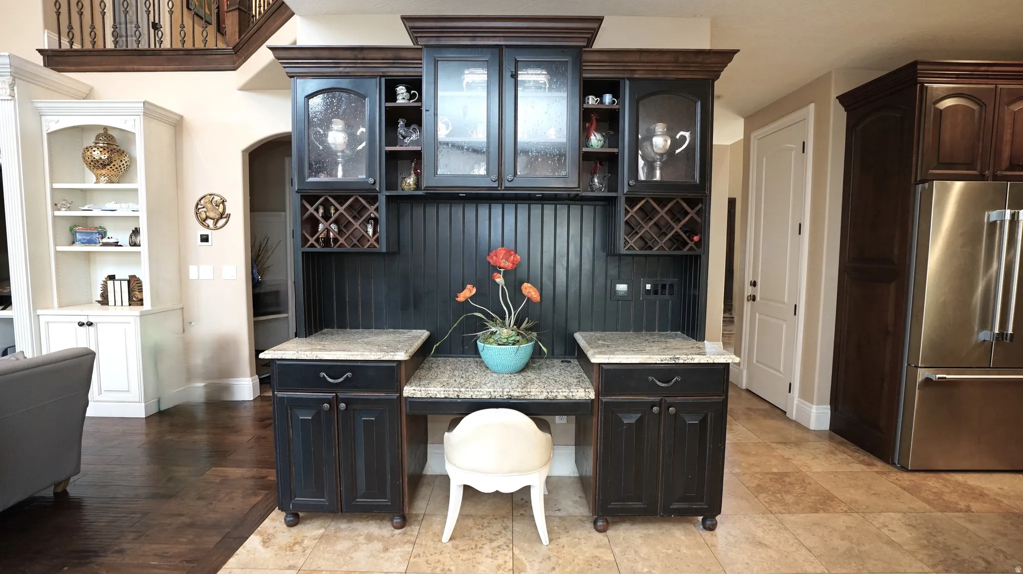 Built-in cabinetry with glass-front uppers, an integrated wine rack, and a beadboard backsplash
