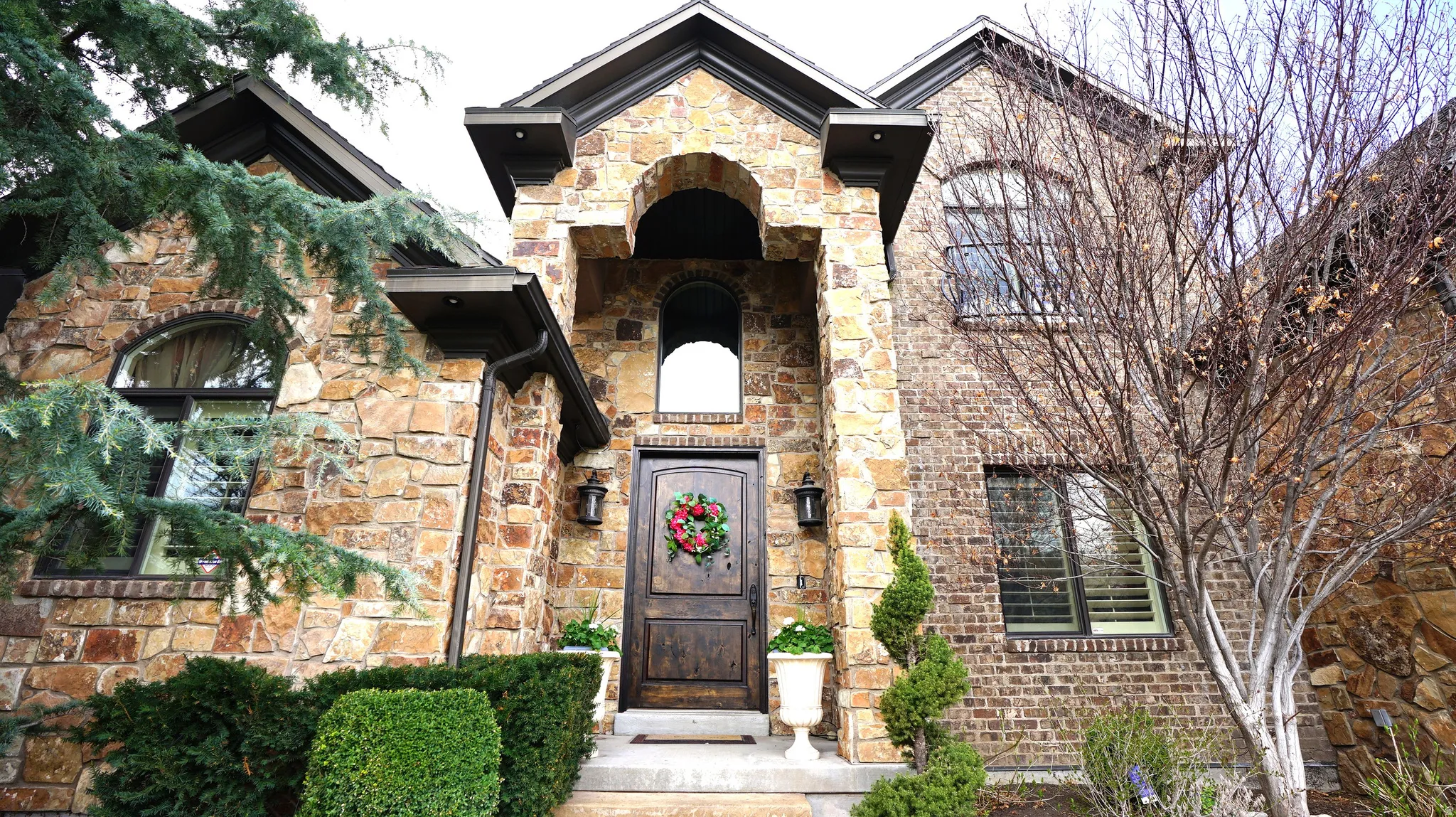 Stone and brick exterior with an arched entryway