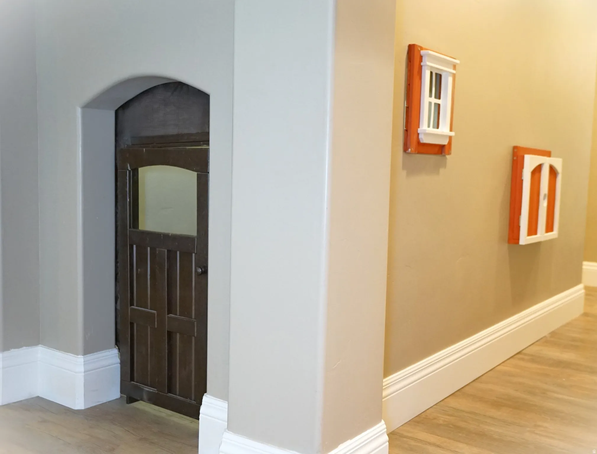 Archway featuring a dark wood-paneled door
