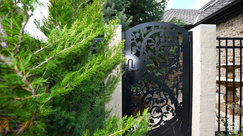 Decorative wrought iron gate featuring an intricate tree design