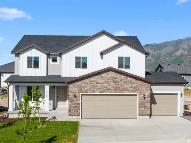 Modern construction featuring a stone and vertical siding exterior