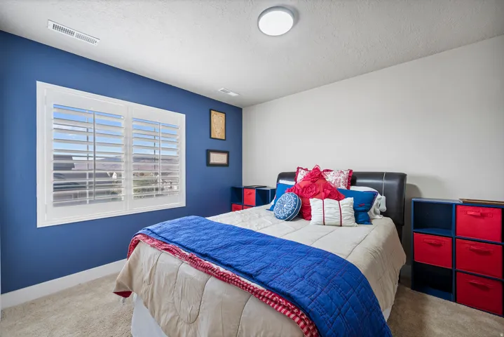 Window with plantation shutters, carpeted flooring, and a flush mount ceiling light