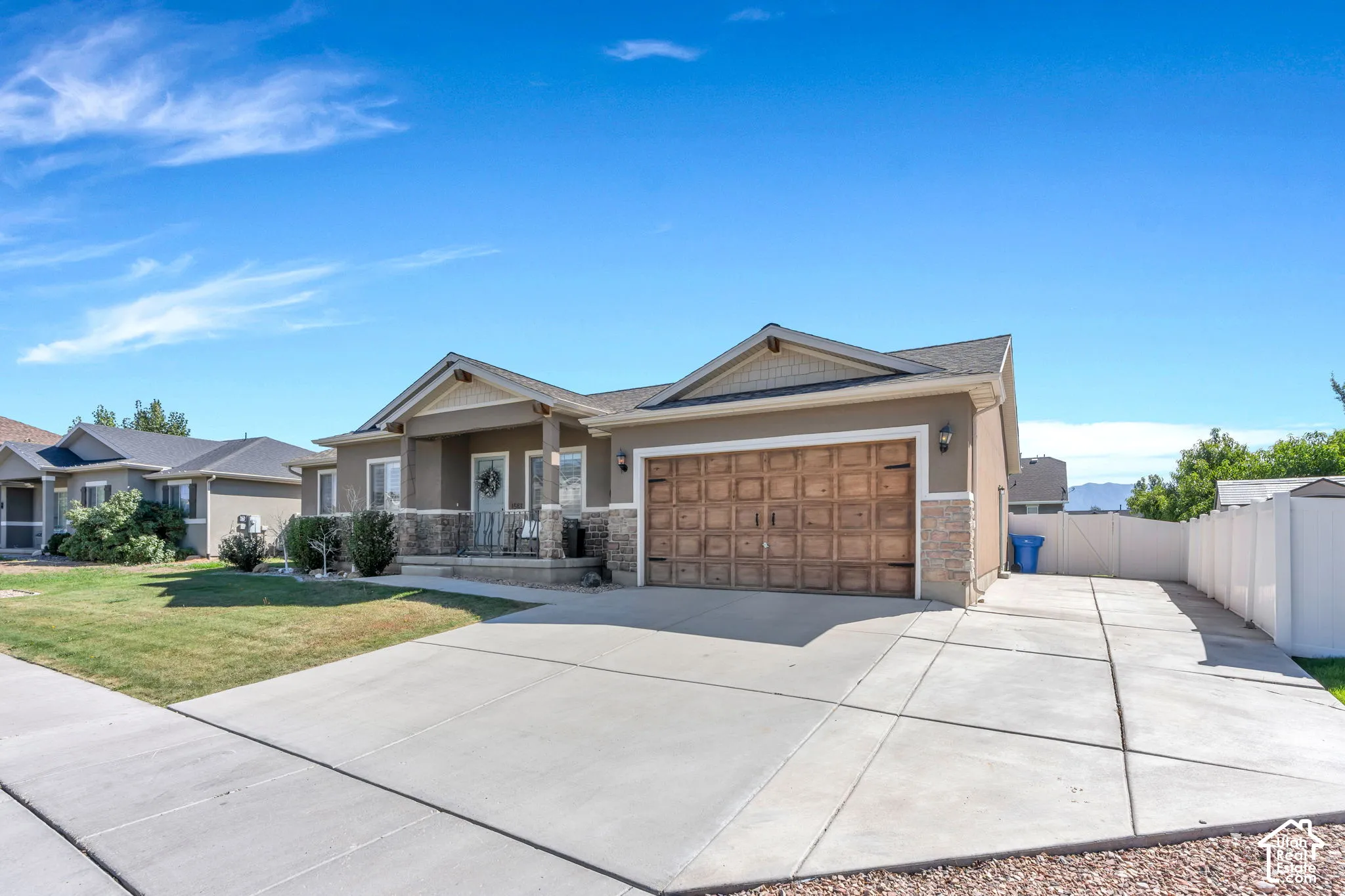 Stucco exterior with stone accents and a covered porch