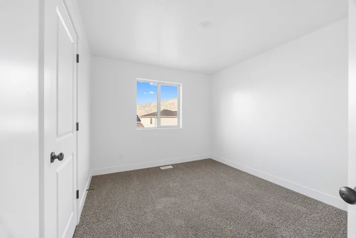 Neutral paint palette with recessed lighting and a window