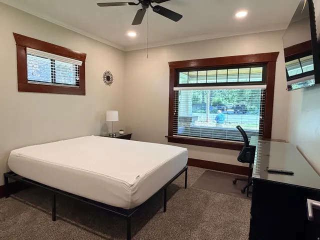 Recessed lighting, ceiling fan, warm-toned window trim, and carpeted flooring