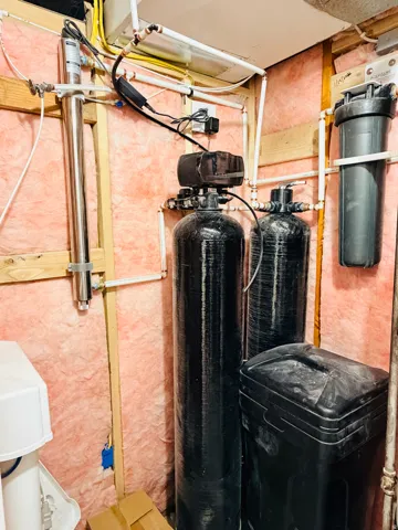Water filtration system with multiple tanks and associated plumbing