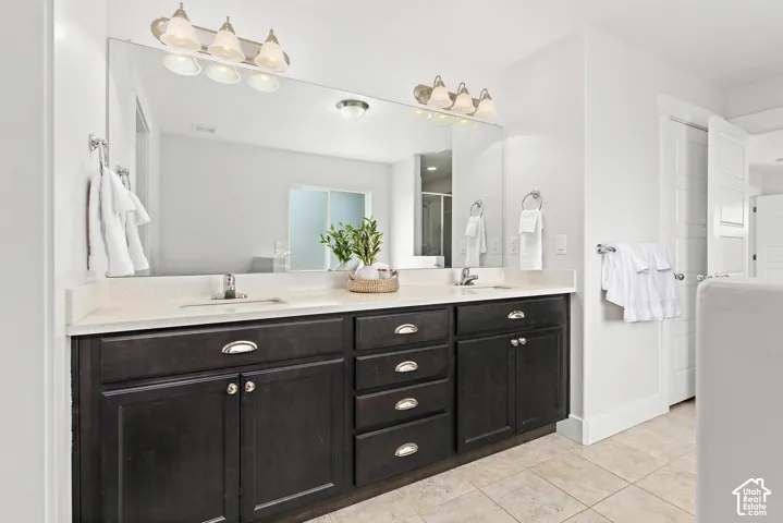 Dual vanity with dark wood cabinetry and light-colored countertops