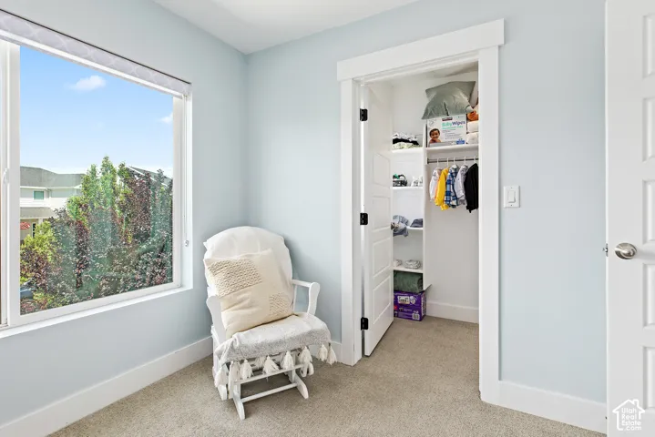 Good size bedroom featuring a large window and walk in closet with a window