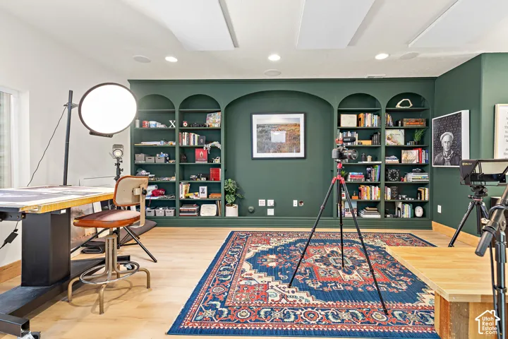 Versatile podcast, art studio, family room featuring sound-absorption ceiling panels and wall treatments, elevated custom finishes, thoughtfully designed built-ins, designer lighting, and upgrades