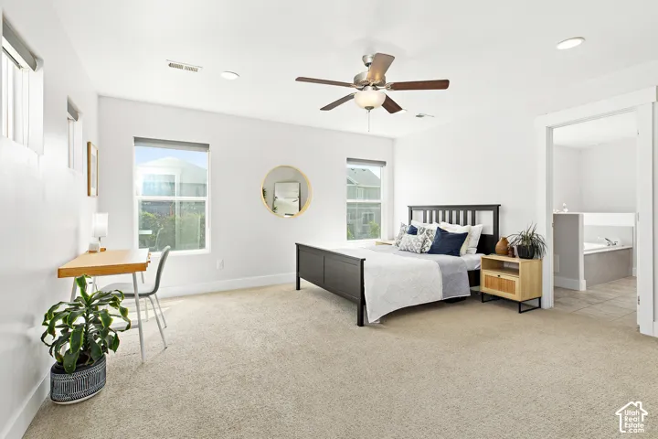 Oversized primary suite with room for a desk, abundant natural light, beautiful views, ensuite bathroom, and walk in closet