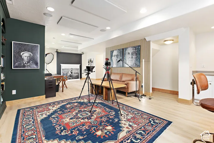 Versatile podcast, art studio, family room featuring sound-absorption ceiling panels and wall treatments, elevated custom finishes, thoughtfully designed built-ins, designer lighting, and upgrades