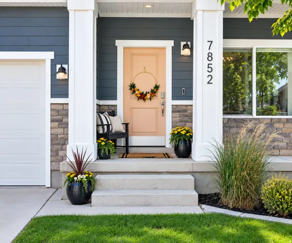 Inviting front entry with a welcoming porch extending the full length of the home