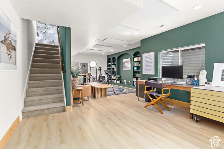 Versatile podcast, art studio, family room featuring sound-absorption ceiling panels and wall treatments, elevated custom finishes, thoughtfully designed built-ins, designer lighting, and upgrades