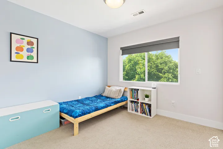 Good size bedroom featuring a large window and walk in closet with a window