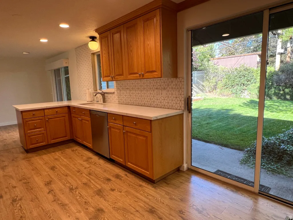 Huge light from two sliding doors on either side of the upgraded kitchen with matching stainless appliances