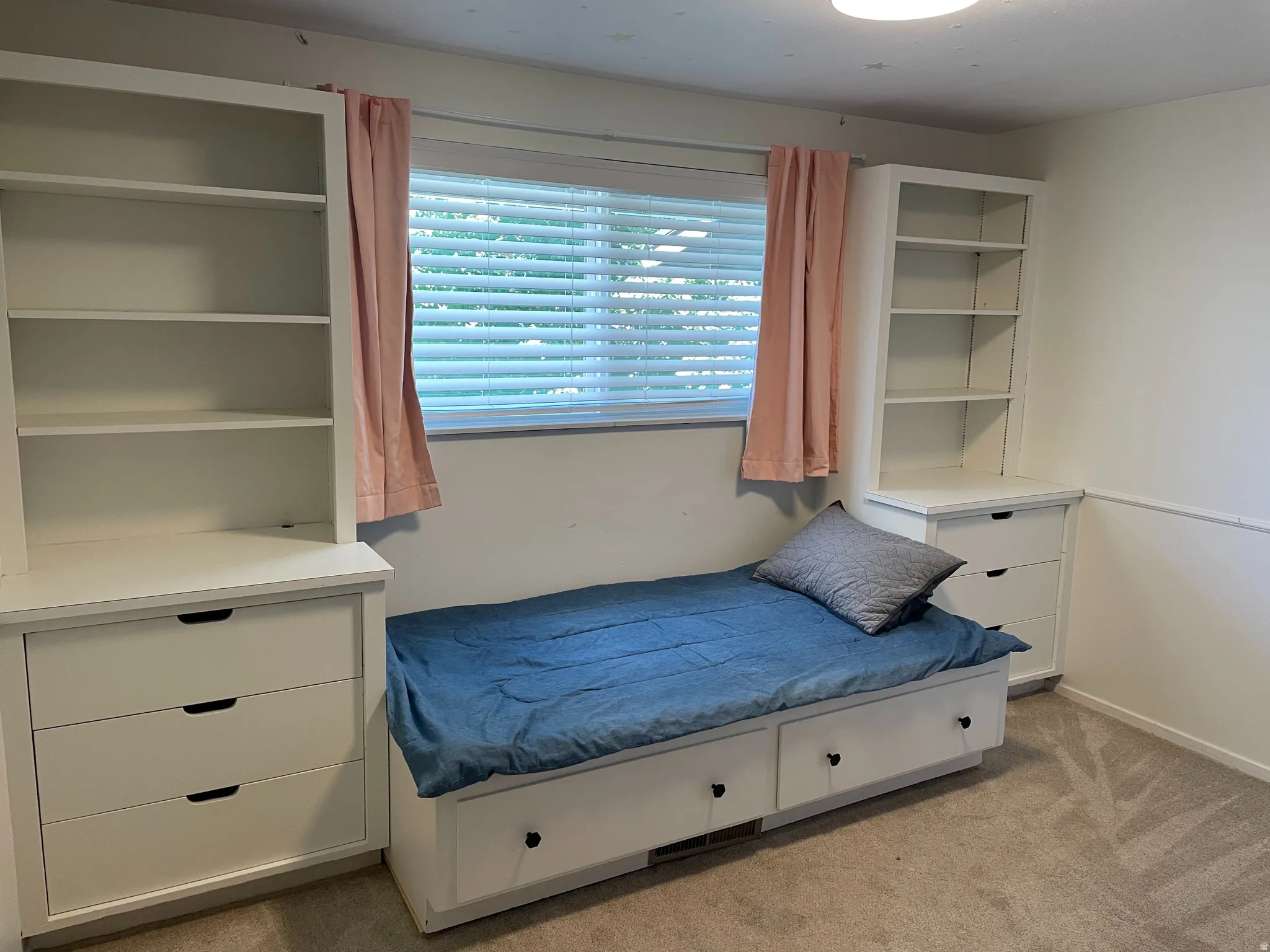 Bedroom 3 with built-in shelving.  A full mattress was put in the virtual stage picture...