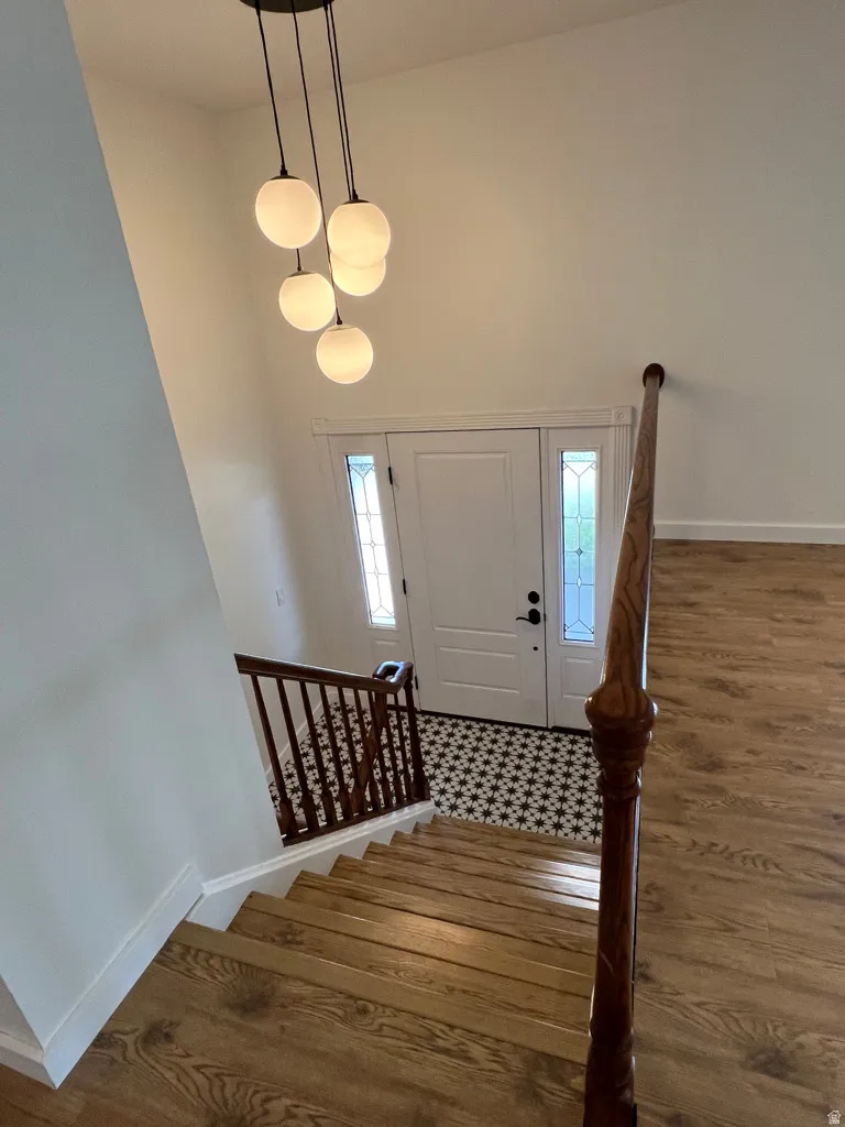 Looking down to the newer "classic-style" white tile floor off the main entry (front door).  The decorative glass sidelights add to the light airy feeling of the home.