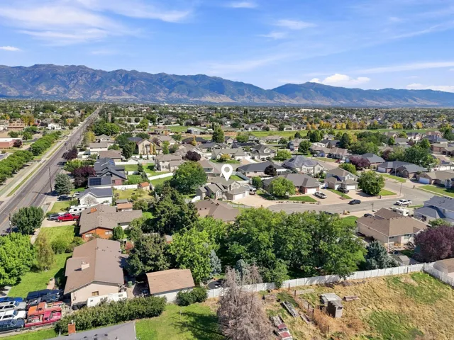 Residential neighborhood with established landscaping and mountain backdrop