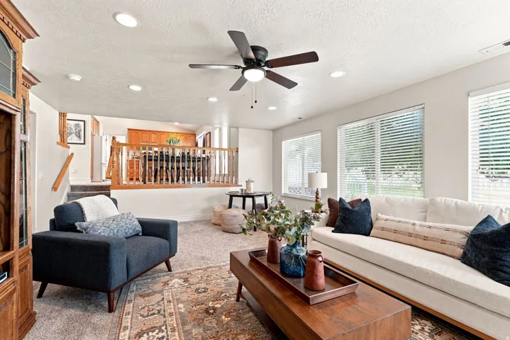 Recessed ceiling lighting, a ceiling fan, and carpeted flooring