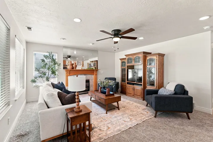 Recessed lighting, ceiling fan, and carpeted flooring