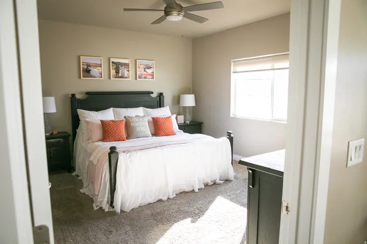 Carpeted room featuring a ceiling fan, window with blinds, and neutral-toned walls