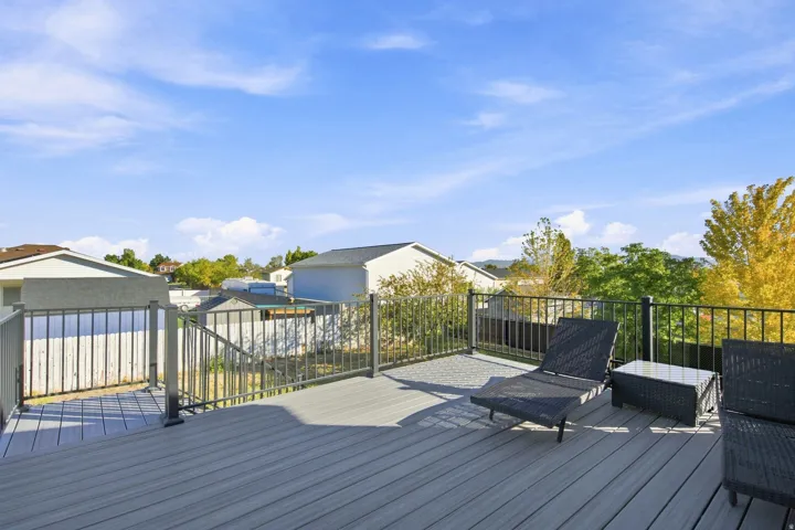 Expansive elevated deck with gray composite decking and black metal railings