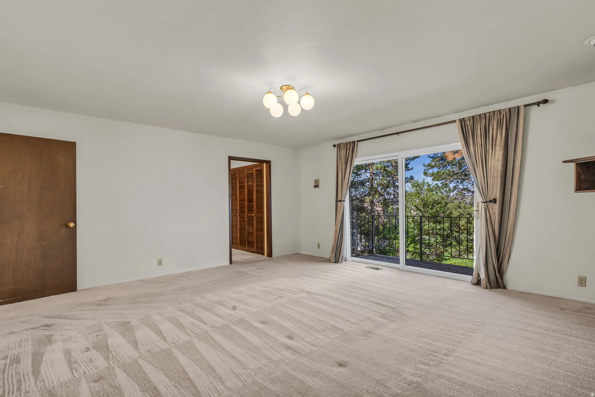 Sliding glass door leading to an exterior balcony