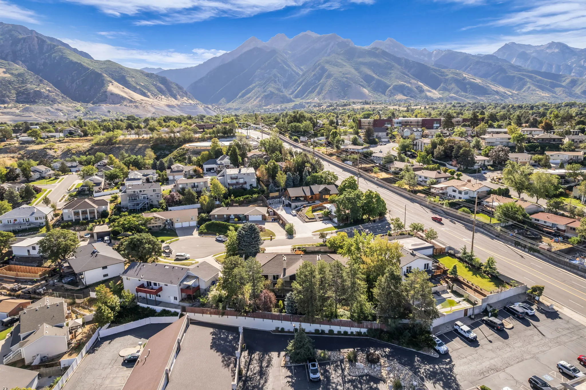 Mountain backdrop with residential properties and a visible roadway