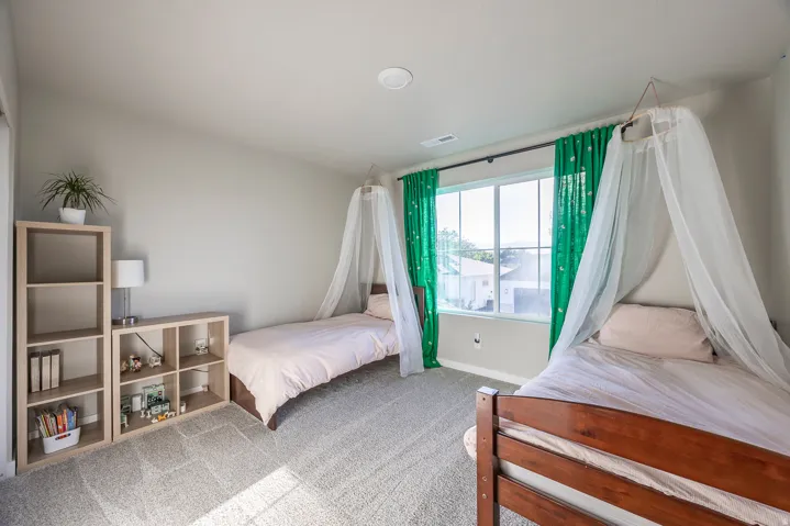Carpeted room with a multi-pane window, recessed ceiling lighting, and light-toned wall paint
