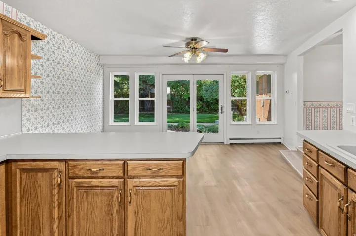 Wood-finish cabinetry with light countertops
