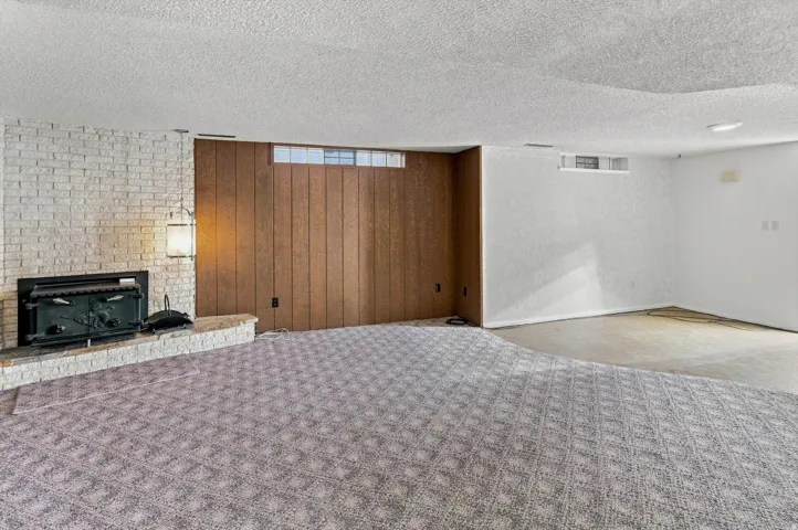 White brick fireplace with an attached wood-burning insert