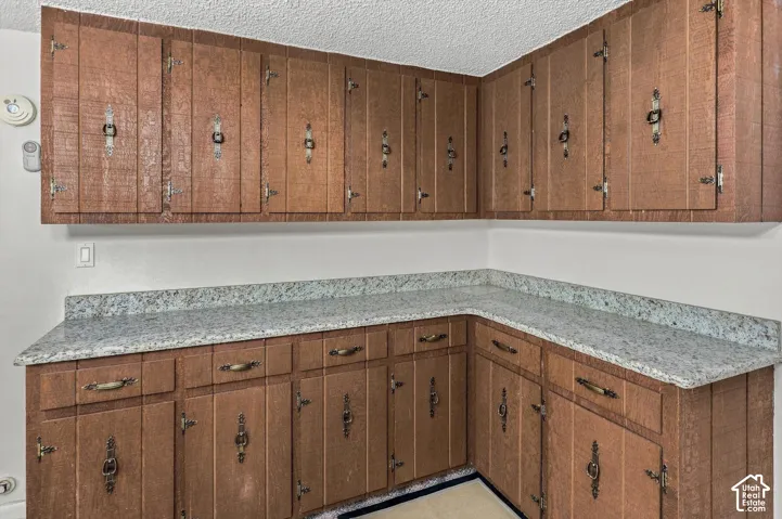 Wrap-around wood-finish cabinetry featuring decorative hardware