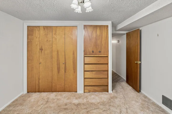 Built-in storage solutions with wood-finish cabinetry and drawers