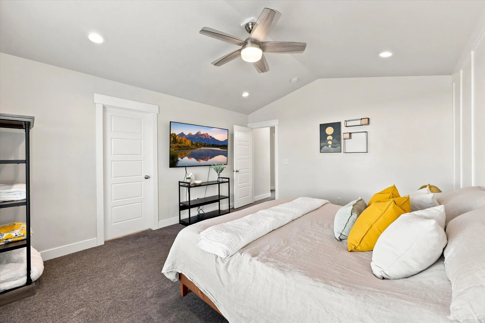 Vaulted ceiling with a ceiling fan and recessed lighting