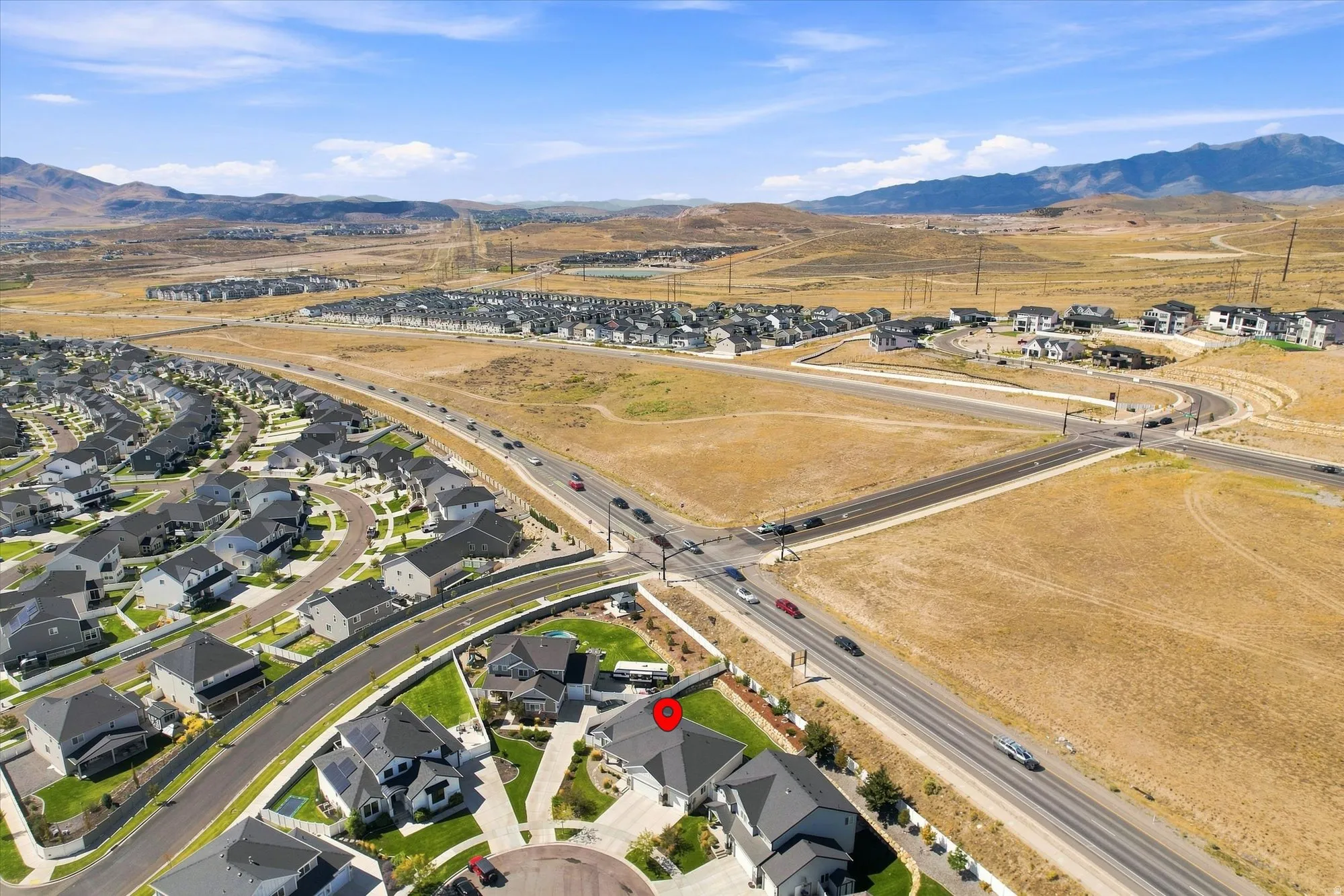 Newly developed residential area with a mountain backdrop, featuring a cul-de-sac and well-maintained properties