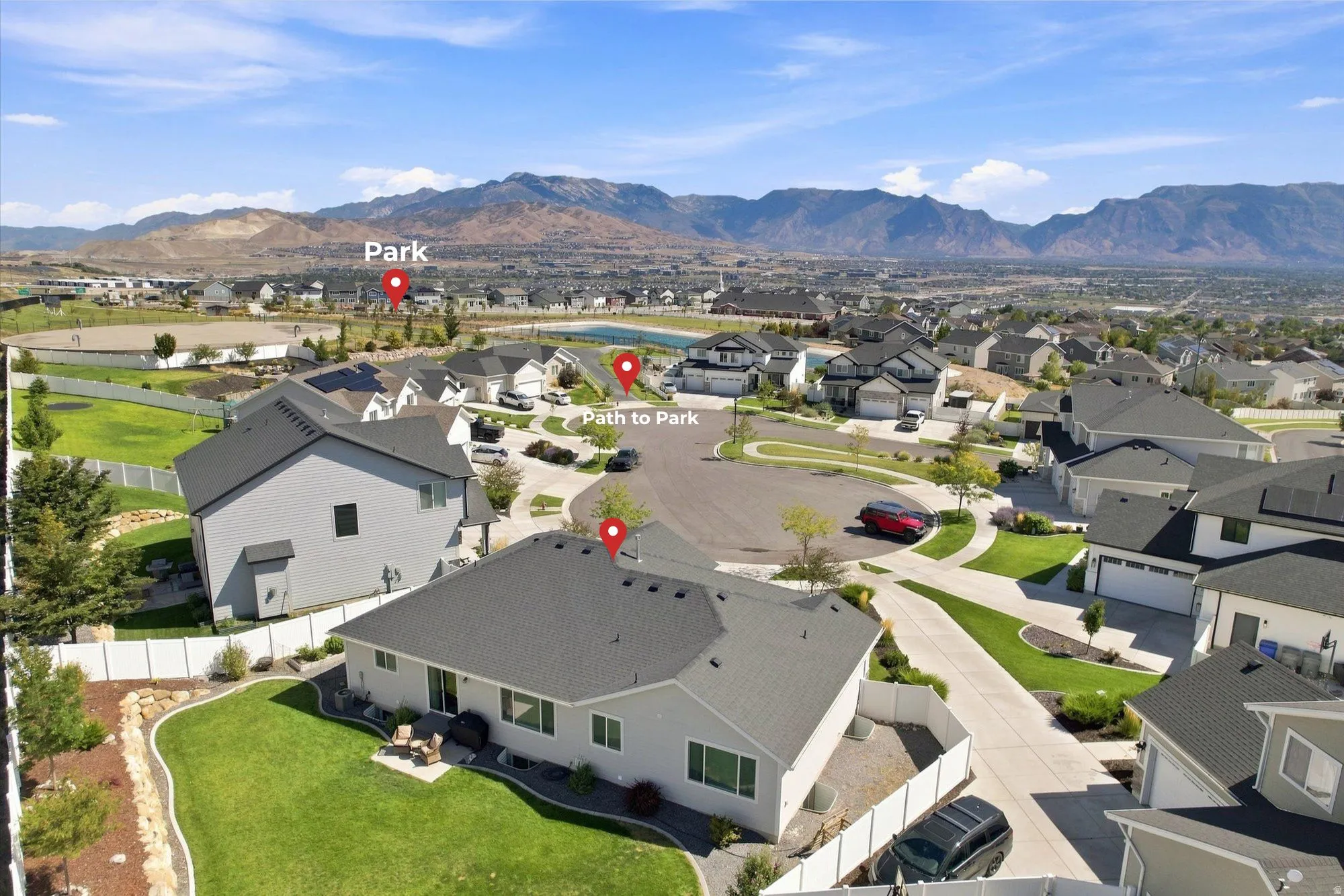 Expansive residential community with consistent architectural styling, well-maintained landscaping, and distant mountain scenery