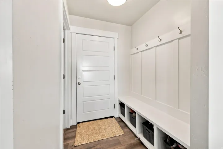 Entryway featuring a built-in bench with storage cubbies, board and batten detailing, and a modern five-panel interior door
