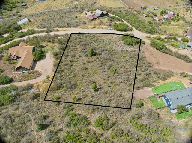 Expansive undeveloped land parcel featuring natural shrubbery and varied topography
