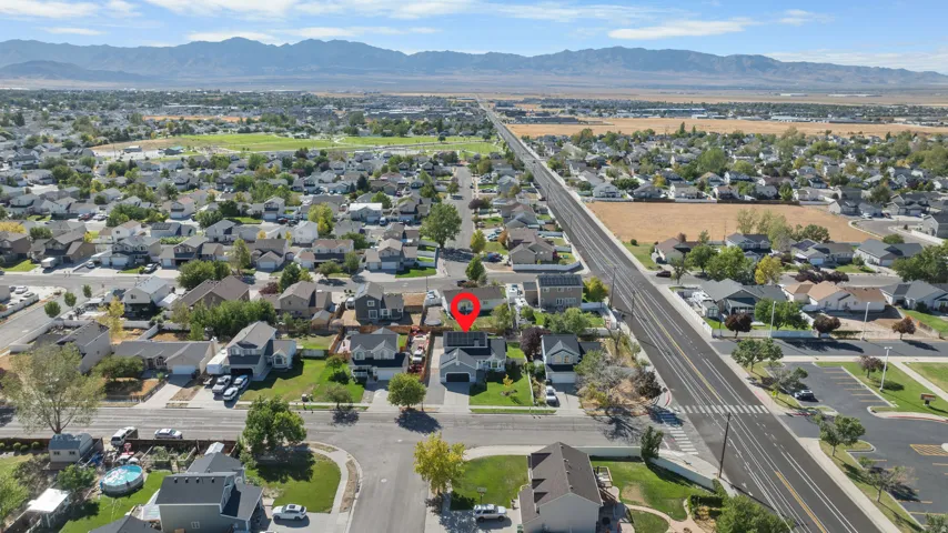 Aerial perspective showcasing a residential neighborhood with distant mountains