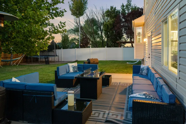 Expansive patio featuring a decorative outdoor rug and direct access to the rear yard