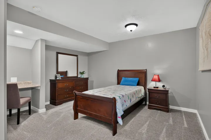 Built-in desk with a stone-finish countertop, recessed lighting, and wall-to-wall carpeting