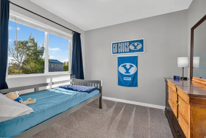 Expansive window with white trim, light gray painted walls, and gray carpet