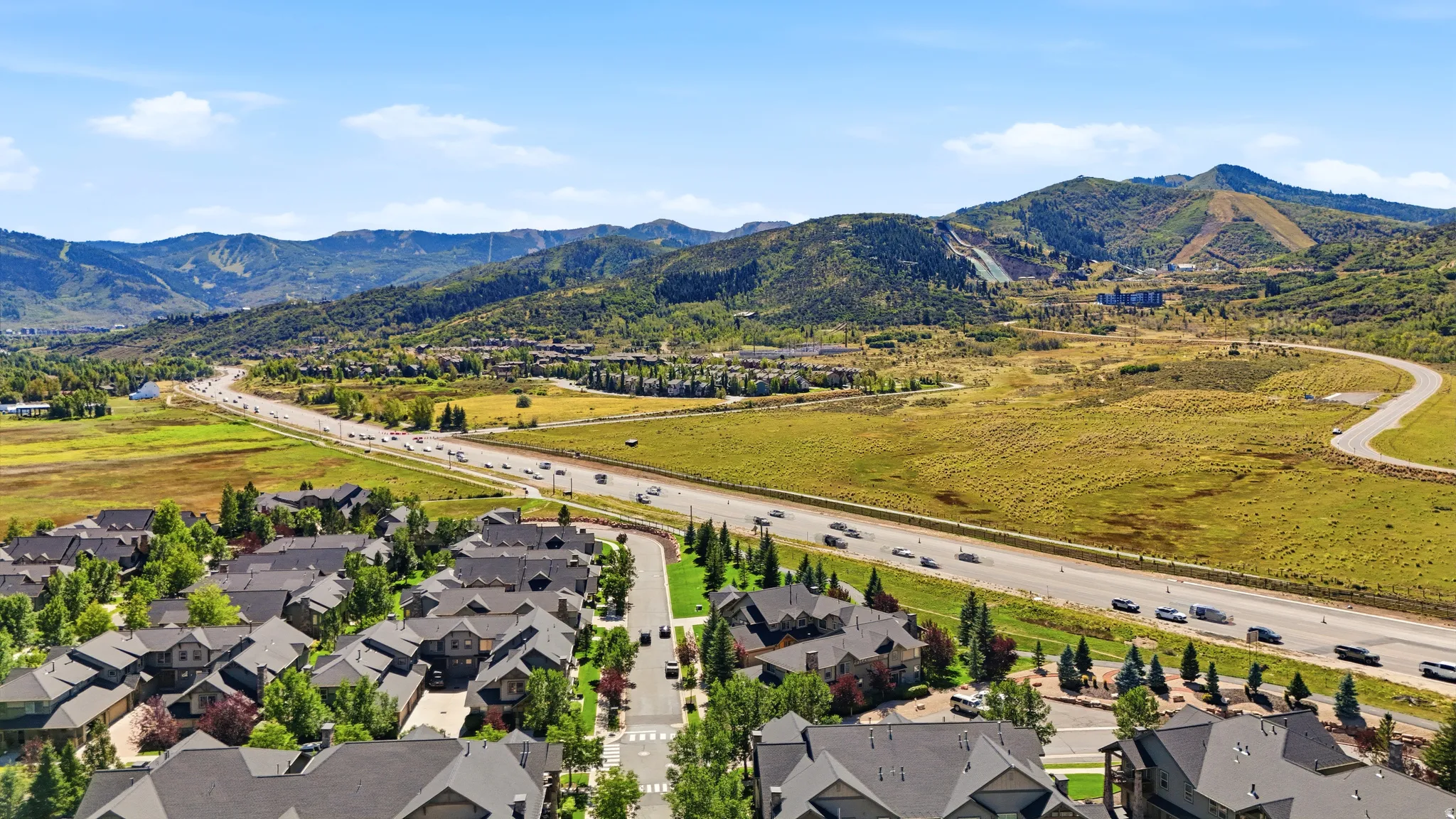Expansive mountain scenery with established residential development and highway access