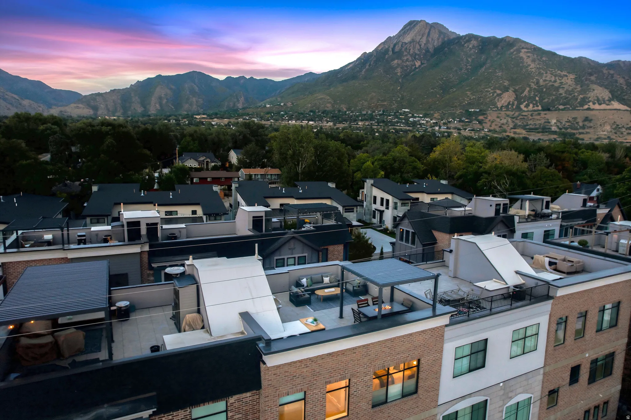 Rooftop patio with a pergola, offering expansive mountain scenery