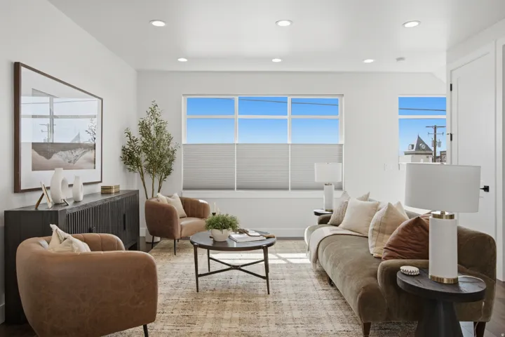 Recessed lighting, wood-finish flooring, multiple windows with blinds, and white interior doors with dark hardware