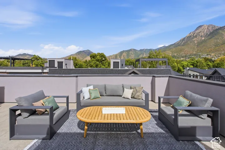 Rooftop terrace with low perimeter walls and a hard-surface floor