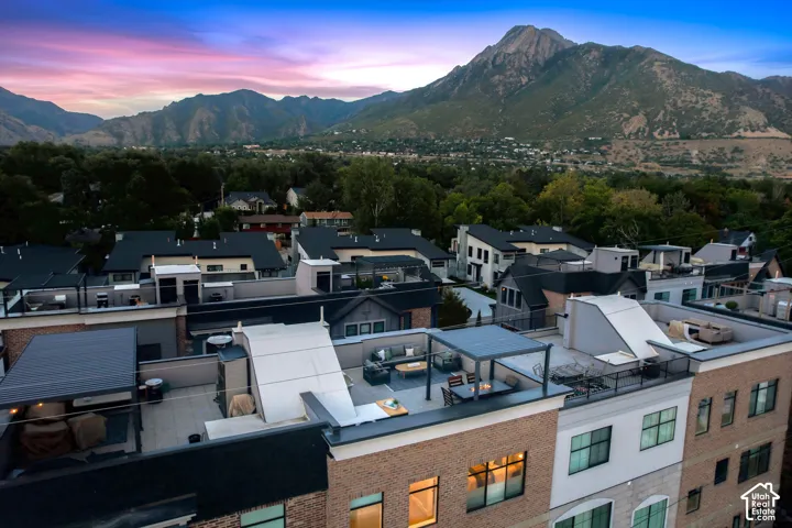 Rooftop patio with a pergola, offering expansive mountain scenery
