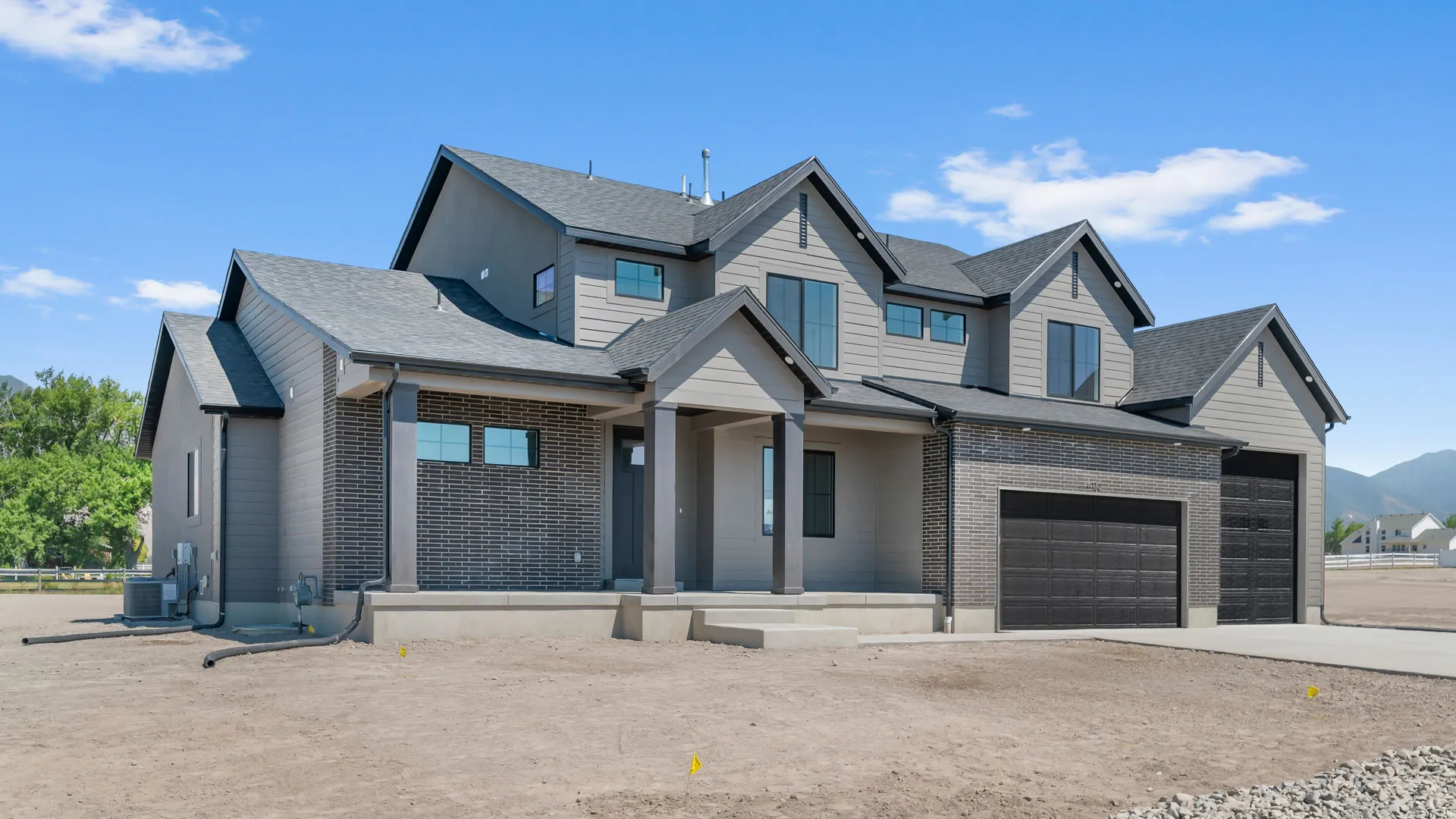 Modern architectural style with multiple gables and a dark gray shingle roof