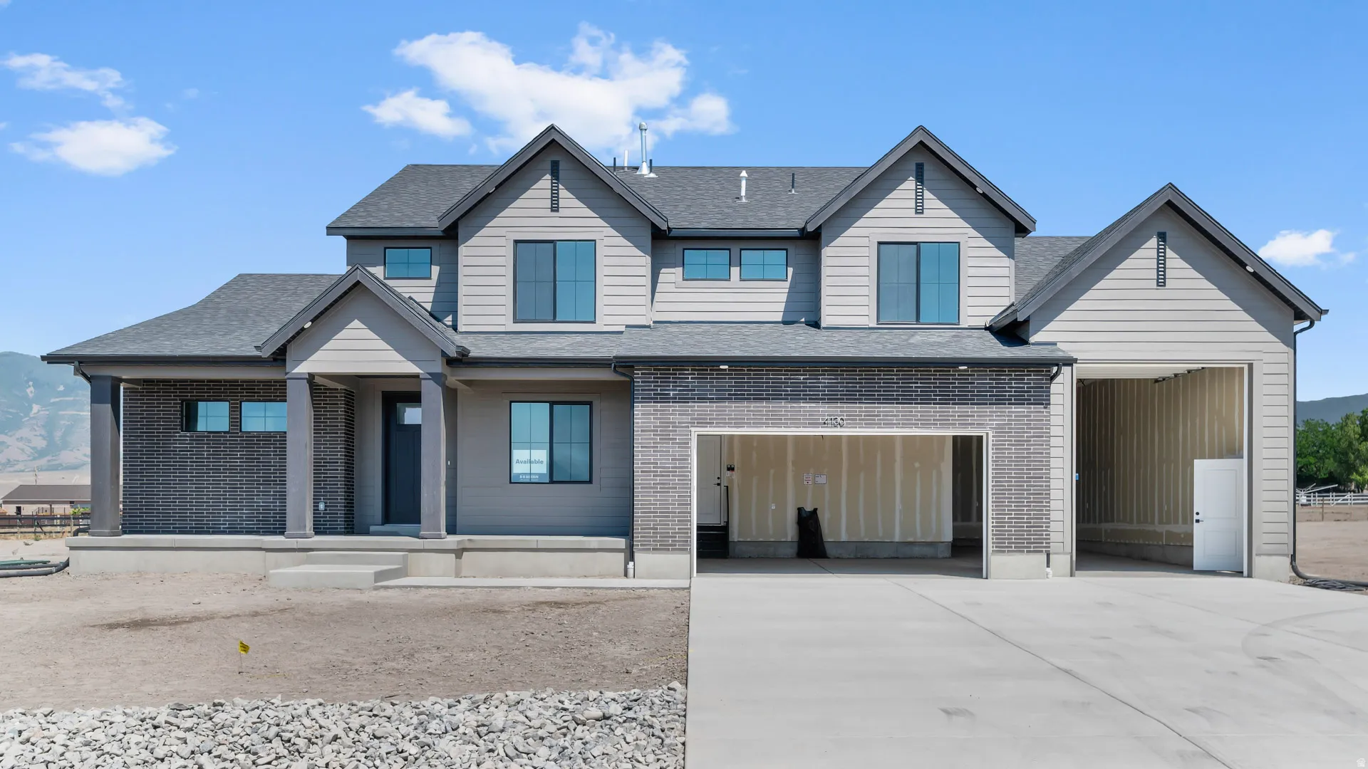 Two-story residence featuring a combination of brick and horizontal siding